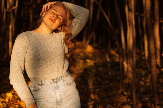 A peaceful portrait of a woman in autumn, surrounded by warm foliage.