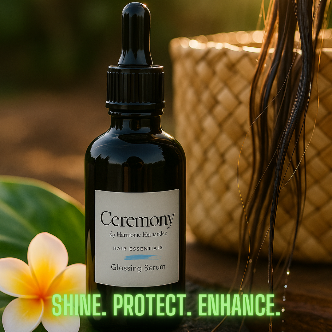 Bottle of Ceremony hair essentials glossing serum with a flower and blurred background